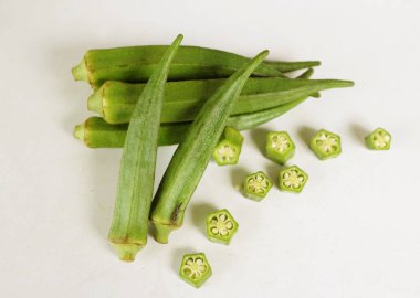 young raw okra, ladys finger, gombo, gumbo, bendee, quimbamto (hisbicus esculentus l.) vegetables .flat lay