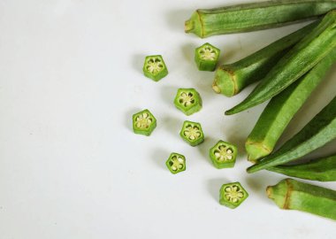 young raw okra, ladys finger, gombo, gumbo, bendee, quimbamto (hisbicus esculentus l.) vegetables .flat lay