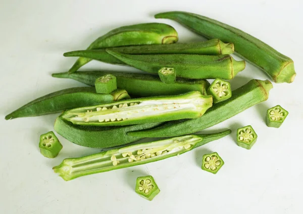 young raw okra, ladys finger, gombo, gumbo, bendee, quimbamto (hisbicus esculentus l.) vegetables .flat lay