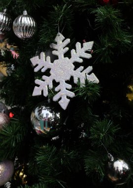 Kıvılcım saçan Noel süsleri. Yeni yılın tüylü konfetisi, çelenk kırmızısı folyo parıltısı. Evde mutluluk aktiviteleri için. Kutlama, tatil, süsleme.