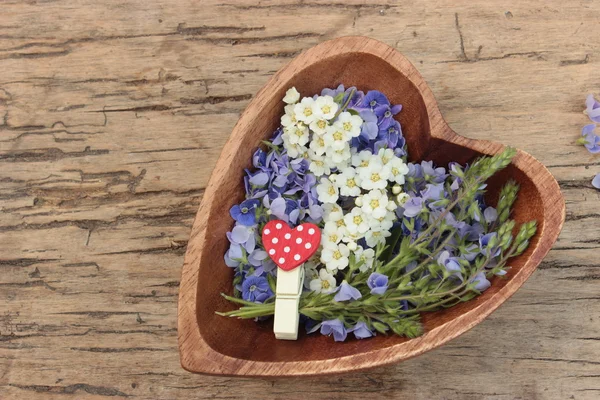 Wooden heart with flowers — Stock Photo, Image