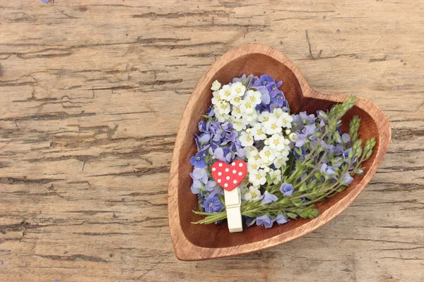 Wooden heart with flowers — Stock Photo, Image