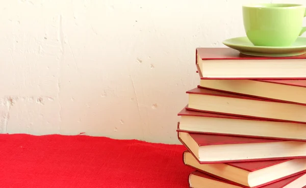 Cup of coffee on stack of books — Stock Photo, Image