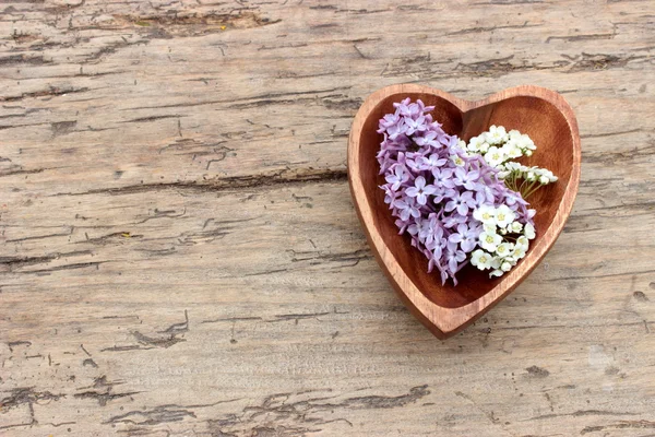 Wooden heart with flowers — Stock Photo, Image