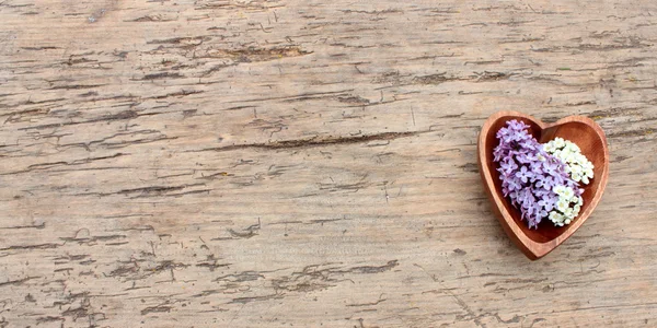 Wooden heart with flowers — Stock Photo, Image