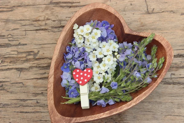 Wooden heart with flowers — Stock Photo, Image
