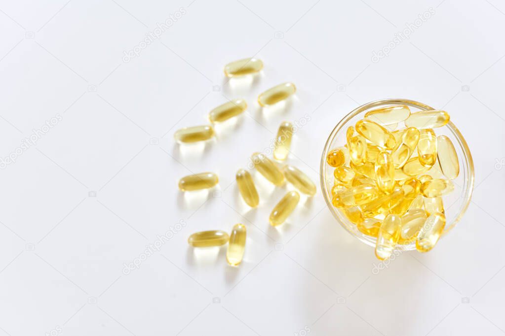 Omega 3 capsules lying on white background. Fish oil in pills. Health support and treatment. Biologically active additives. Selective focus.