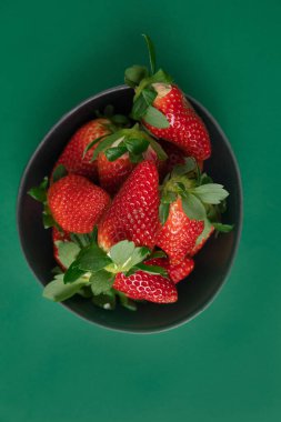 Yeşil arka planda kırmızı çilekler