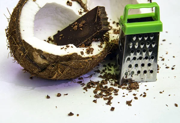 Close up of man hand grated coconut using an electric coconut grater in  Thailand Stock Photo