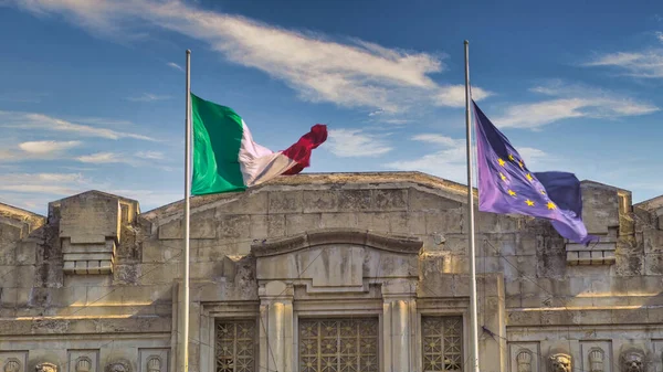 EU flag and Italian flag in Milan, Italy