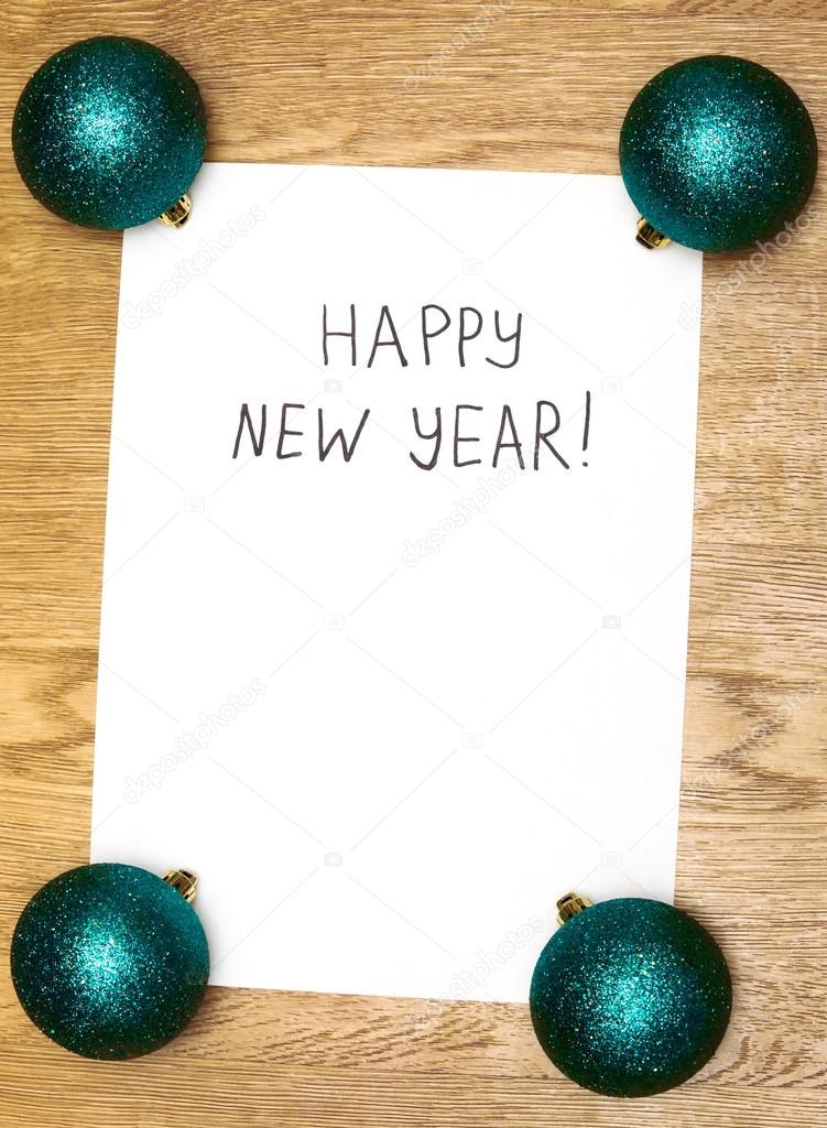 Happy New Year message greeting written on white paper with new