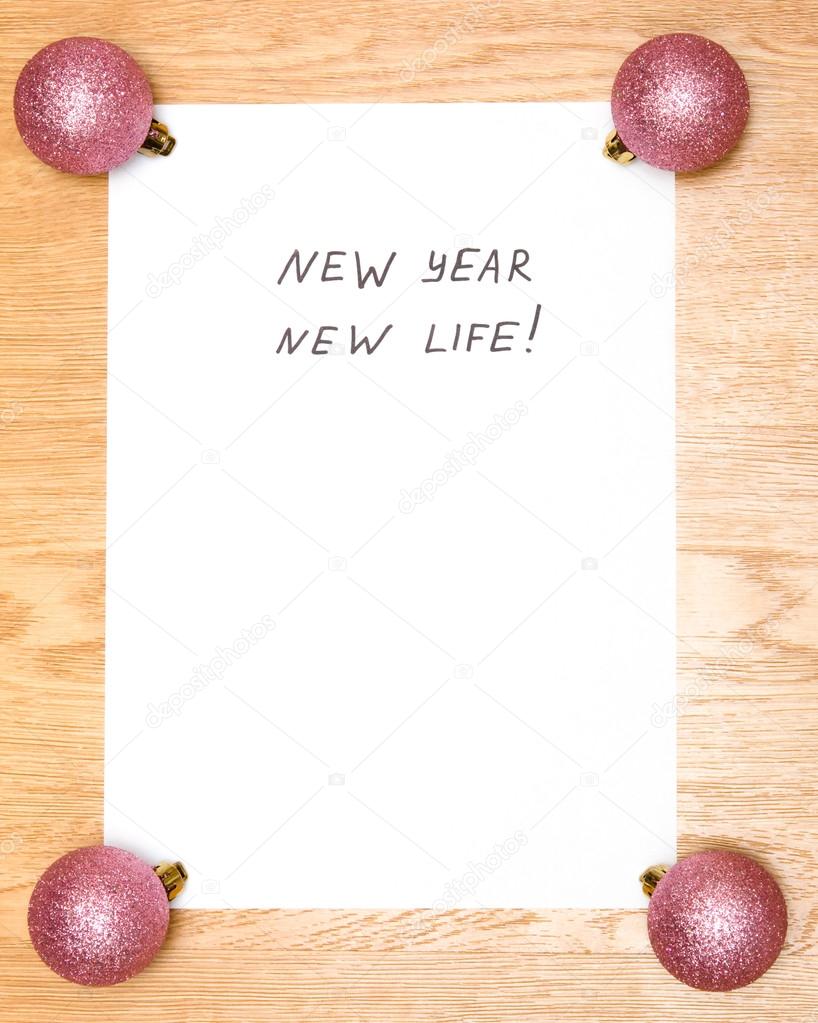 New Year New Life on a blank white paper on wooden background