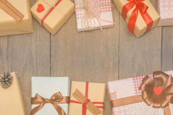 Tarjeta de Navidad con regalos, abeto y conos de pino en madera —  Fotos de Stock