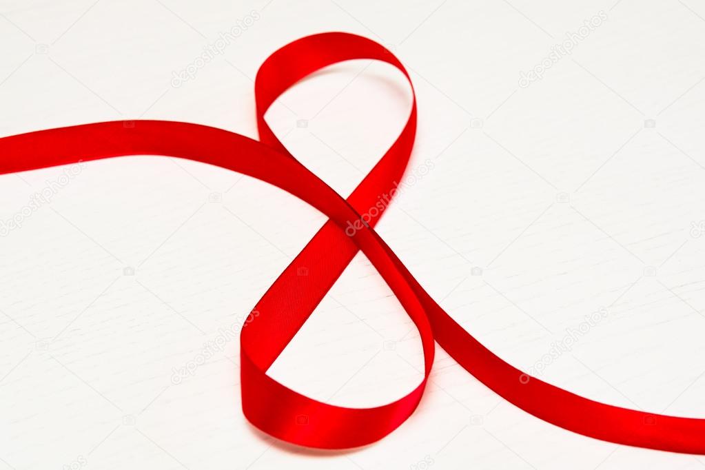 Happy Women's Day. Red gift ribbon in 8 digit shape 