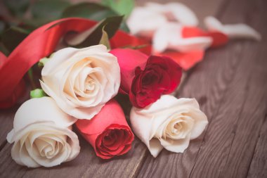 Red and white roses on a dark wooden background. Women' s day, V
