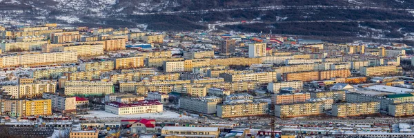 Panorama of the northern Russian city. View of the city block. Winter cityscape. Top view of the streets and buildings. Urban infrastructure and real estate. Magadan, Magadan region, Siberia, Russia.