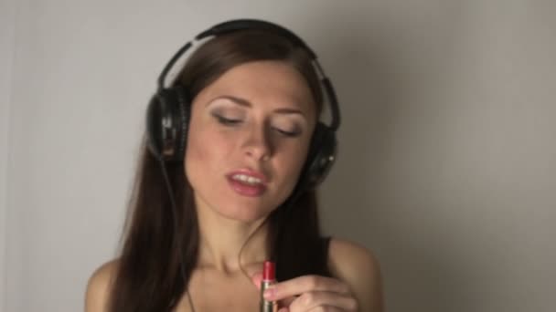 Дівчина слухає музику в навушниках — стокове відео