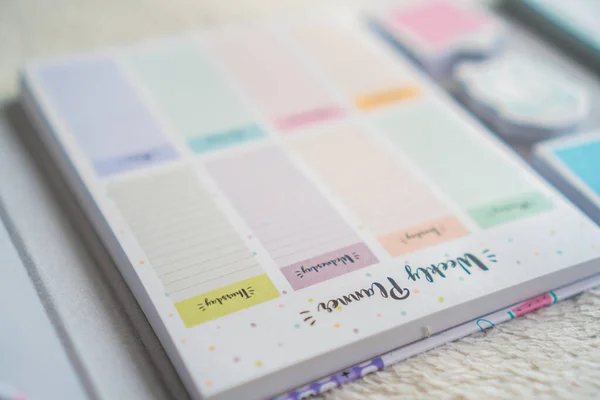 colourful planner and notebook on a white background