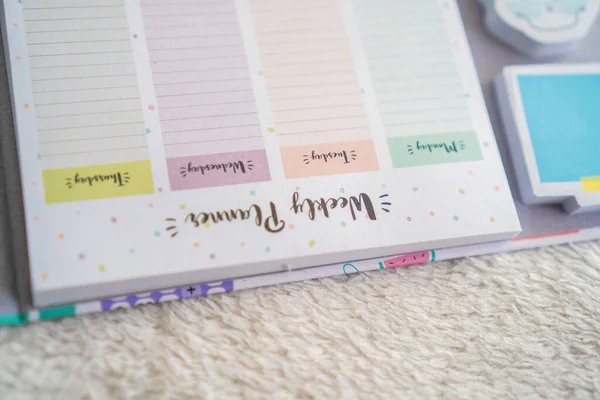 colourful planner and notebook on a white background