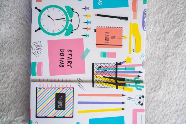 colourful planner and notebook on a white background