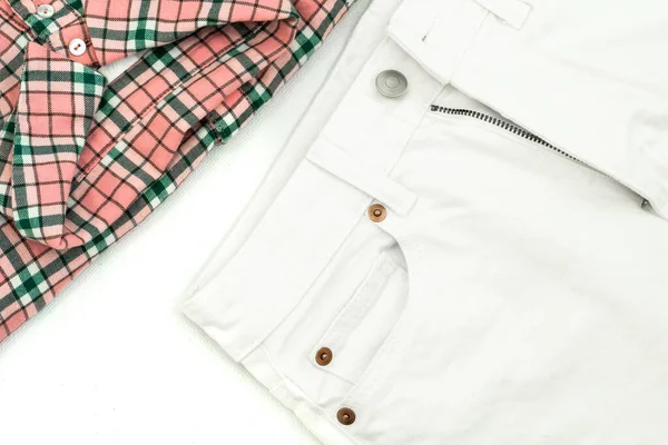 summer flat lay: shirt with a pink check pattern and white jeans