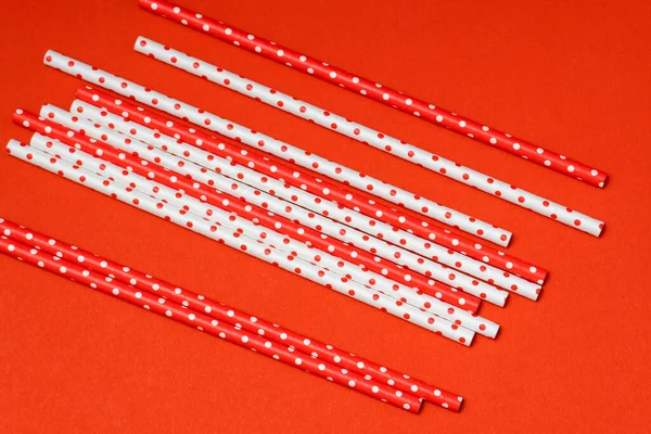 recycled paper straw for drinks red and white colours on a red background