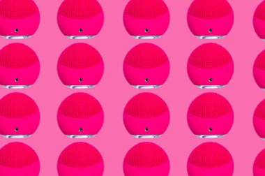 Kozmetik güzellik ürünlerinin yaratıcı desenli fotoğrafı pembe arka planda mor yüz bakım fırçası