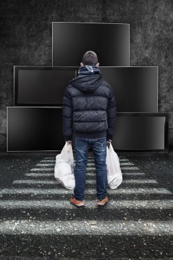 a young boy stays in front of tv screens and looking to the tv static pictures clipart