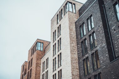 Kahverengi, beyaz ve siyah renkli uzun ince pencereli apartmanların alçak açılı görüntüsü