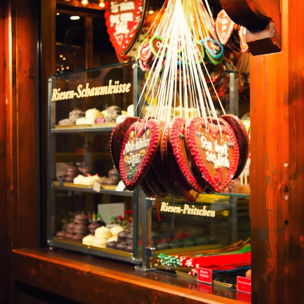 Close up of traditional German heart shaped Christmas biscuits hanging in bakery window