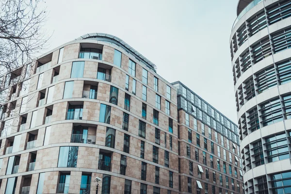 stock image Low Angle Architectural Exterior View of Modern Residential Apartment Building with Small Balconies in Urban City Neighborhood on Overcast Day with Gloomy Gray Sky