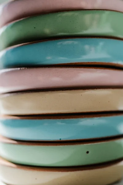 A large stack of ceramic cups in pastel colors. — Stock Photo, Image