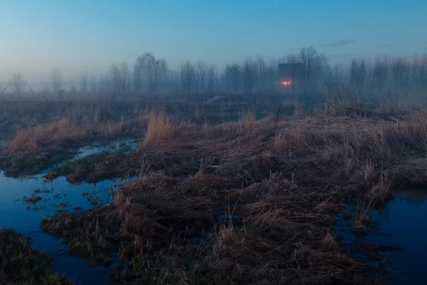 Alone house in the evening fog