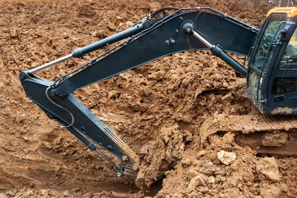 Three excavators in the process of work digs