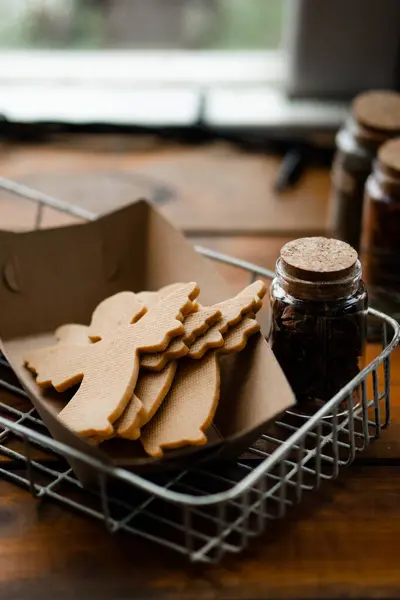Kış havası. Ahşap pencere pervazındaki el işi kağıt kutuda duran Noel meleklerinin lezzetli şekilli kurabiyelerinin yakın görüntüsü. Tatlı kurabiye konsepti. Stok fotoğrafı