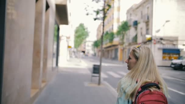 책 가방을 가진 어린 소녀 슬로우 모션에서 거리를 걸어 — 비디오