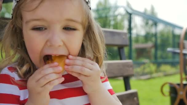 Menina ensolarada com damasco comendo alegremente frutas — Vídeo de Stock
