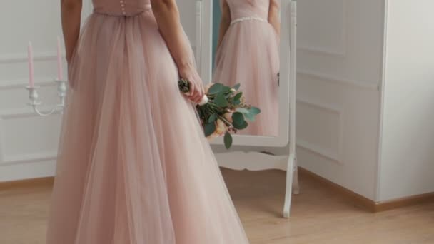 Beautiful bride with the bouquet near the mirror — Stock Video