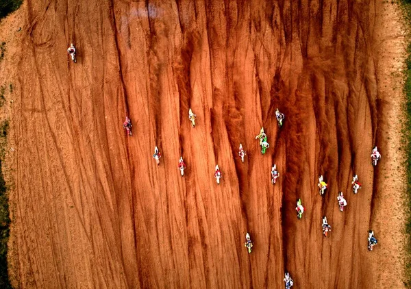 Starting glade Motocross. Start of athletes. Start of the motorcycle race. Dust from the wheels. Photo from the drone. Photo from above