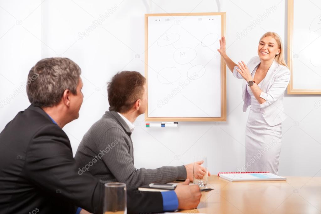 Giving presentation young woman pointing flip chart