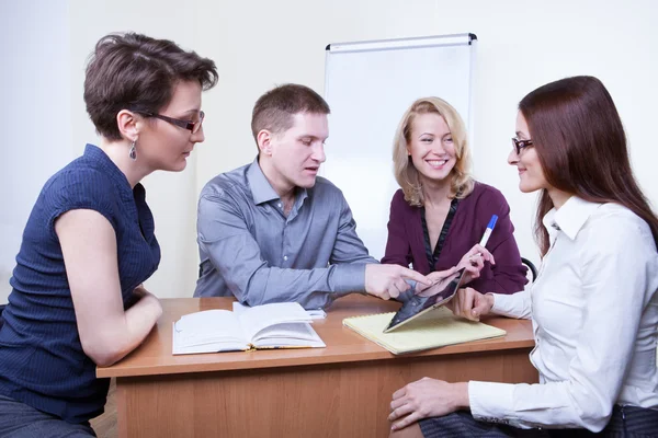 Businesspeople working together at meeting table in office — Stock Photo, Image