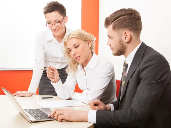 Business people working together on laptop in office at desk — Stock Photo, Image