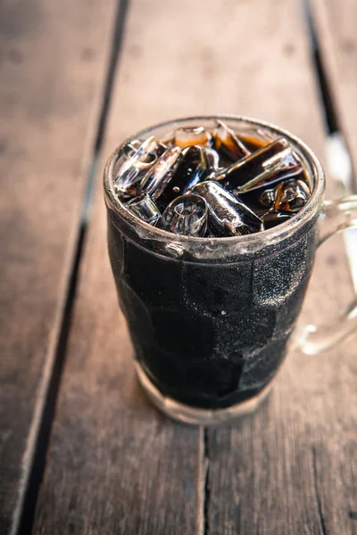 Iced Black Coffee on wooden background Royaltyfria Stockbilder