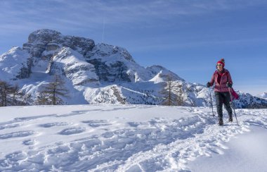 Prato Piazzo 'dan Monte Specie' ye kadar uzanan ünlü Üç Tepe 'nin altında kar ayakkabısı giyen aktif son sınıf öğrencisi bir kadın. İtalya' nın güneyindeki Innichen kasabası yakınlarındaki üç meşe Dolomite bölgesinde.