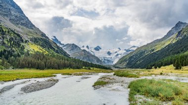 Mountain landscape in the Roseg valley below the melting glaciers and summits of the Sella Group and Piz Roseg, Engadin, Graubuenden, Switzerland