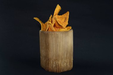 Siyah arka planda bambu camlı tortilla atıştırmalığı.