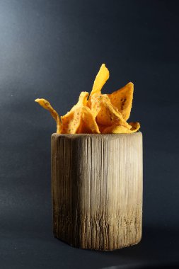 Siyah arka planda bambu camlı tortilla atıştırmalığı.