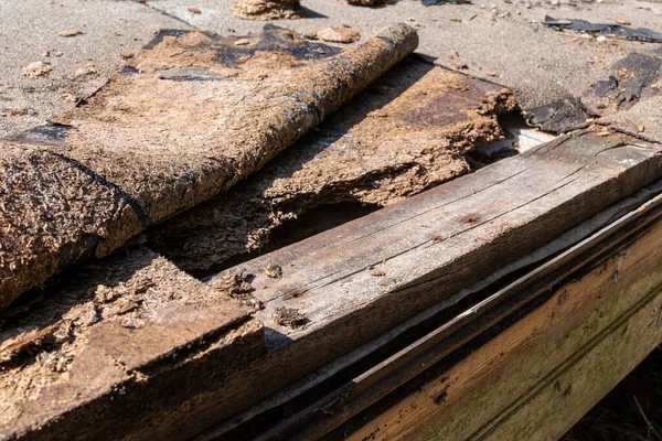 defectation - damaged roof waterproofing and broken OSB board