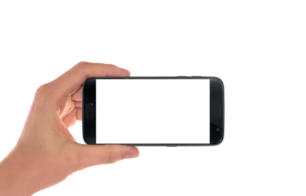 Modern telepon pintar hitam di tangan manusia dalam posisi horizontal. Layar putih untuk mockup, terisolasi . — Stok Foto