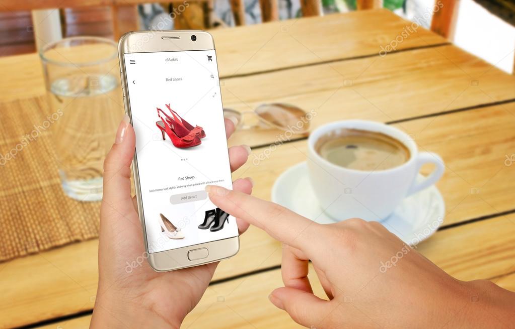 Online shopping with smart phone. Isolated phone in woman hand. Buying women shoes on online store